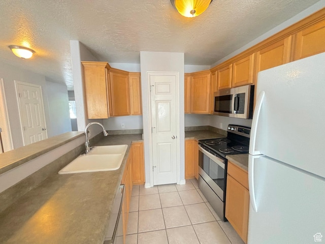 10521 S Sage Flats Way S, Jordan, UT 84009 - kitchen featuring stainless steel appliances, a textured ceiling, and light tile patterned floors