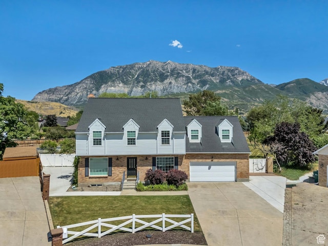 1040 E 900 N, Orem, UT 84097 - cape cod house with concrete driveway, a mountain view, and brick siding