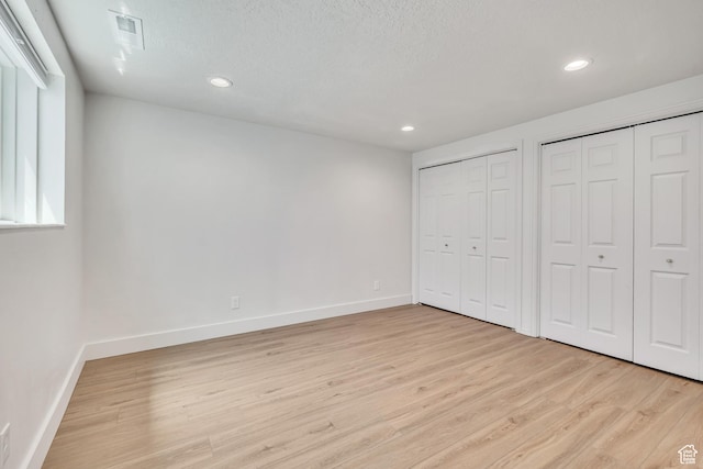 1040 E 900 N, Orem, UT 84097 - unfurnished bedroom with two closets, light wood-style flooring, and recessed lighting