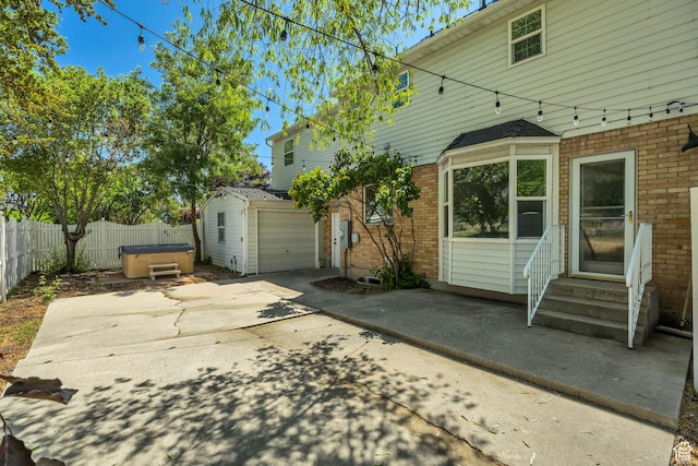 1040 E 900 N, Orem, UT 84097 - view of patio featuring a hot tub, entry steps, and concrete driveway
