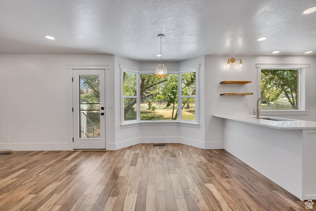 1040 E 900 N, Orem, UT 84097 - unfurnished dining area featuring a textured ceiling, healthy amount of natural light, wood finished floors, and recessed lighting