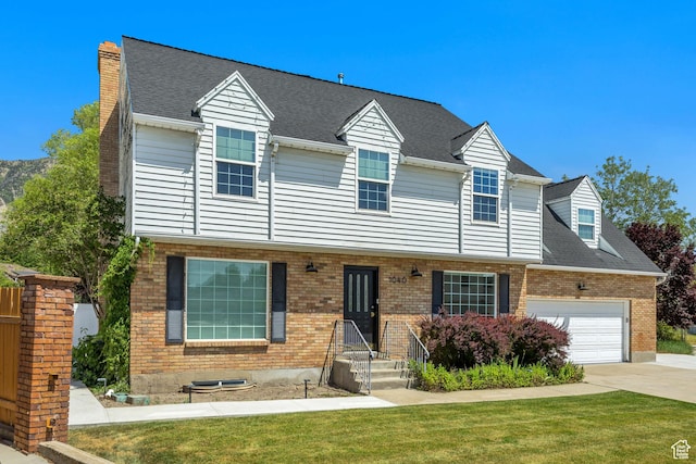 1040 E 900 N, Orem, UT 84097 - view of front of home with brick siding, an attached garage, driveway, and a front yard