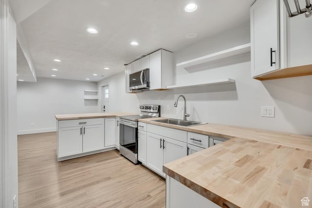 1040 E 900 N, Orem, UT 84097 - kitchen with stainless steel appliances, open shelves, a peninsula, butcher block countertops, and light wood-style floors