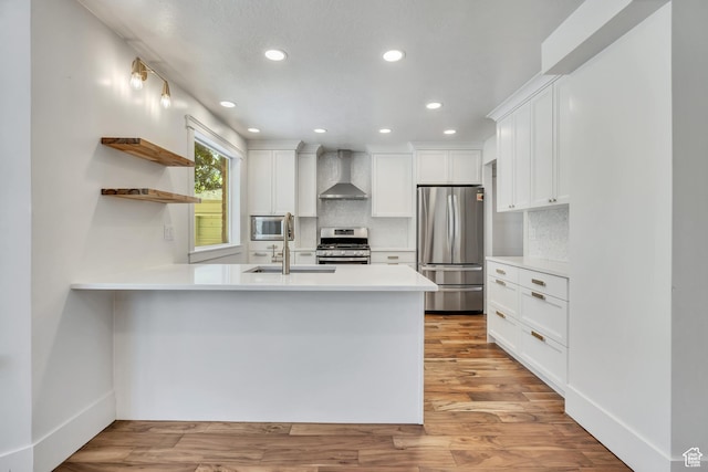 1040 E 900 N, Orem, UT 84097 - kitchen with stainless steel appliances, wall chimney exhaust hood, open shelves, a peninsula, and recessed lighting