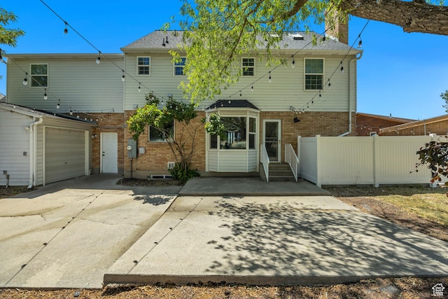 1040 E 900 N, Orem, UT 84097 - back of house with brick siding, a chimney, concrete driveway, and entry steps