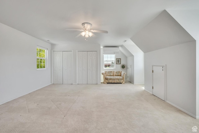 1040 E 900 N, Orem, UT 84097 - unfurnished bedroom with multiple closets, a wall unit AC, light colored carpet, ceiling fan, and lofted ceiling