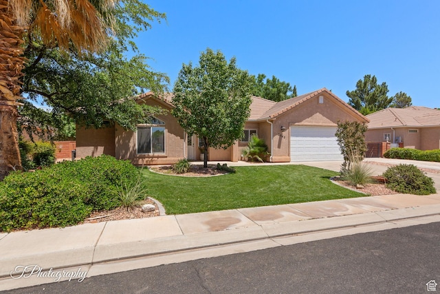 2640 W 200 N, Hurricane, UT 84737 - view of front facade featuring a tiled roof, an attached garage, stucco siding, and a front lawn