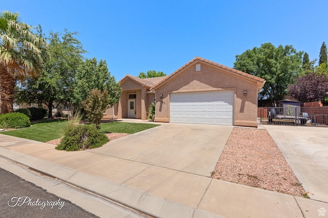 2640 W 200 N, Hurricane, UT 84737 - view of front of home featuring concrete driveway, a garage, stucco siding, and a tile roof