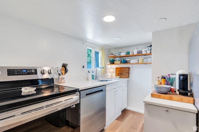 555 N 800 E, Provo, UT 84606 - kitchen with stainless steel appliances, open shelves, white cabinets, light countertops, and light wood-style floors