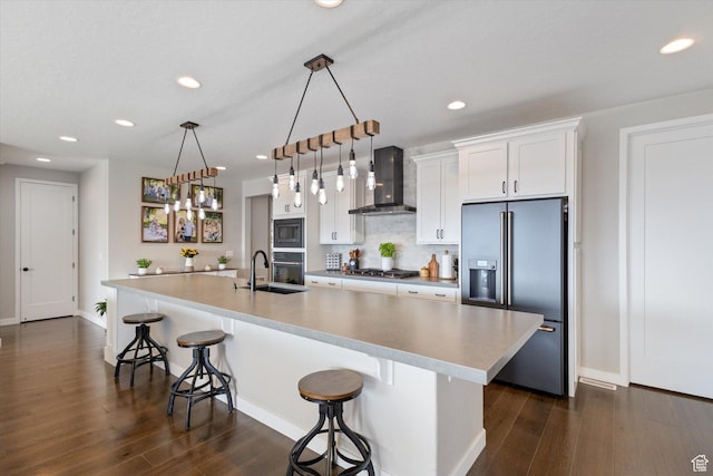 1414 S 790 E, Salem, UT 84653 - kitchen with wall chimney exhaust hood, appliances with stainless steel finishes, a breakfast bar area, dark wood-style flooring, and recessed lighting