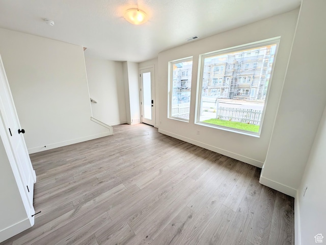 10634 S Cardinal Park Rd W Unit 148, South Jordan, UT 84009 - unfurnished room with light wood finished floors and a smoke detector