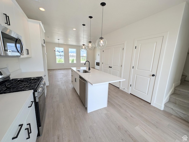 10634 S Cardinal Park Rd W Unit 148, South Jordan, UT 84009 - kitchen featuring stainless steel appliances, light wood finished floors, recessed lighting, light countertops, and an island with sink