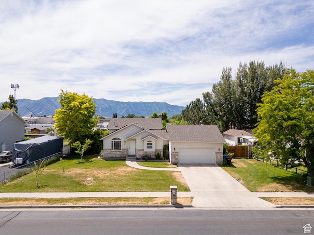 2891 S 600 W, Nibley, UT 84321 - ranch-style home with a garage, driveway, a mountain view, and stone siding