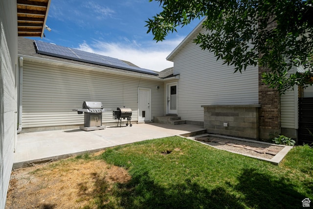 2891 S 600 W, Nibley, UT 84321 - rear view of property featuring roof mounted solar panels, a yard, a patio, and a shingled roof