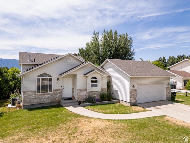 2891 S 600 W, Nibley, UT 84321 - view of front of property featuring an attached garage, driveway, brick siding, and a front yard