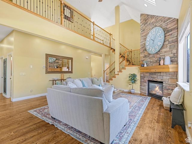 385 W Riverside Ln, Spanish Fork, UT 84660 - living room featuring high vaulted ceiling, wood finished floors, a fireplace, and stairs