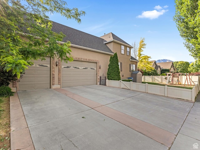 385 W Riverside Ln, Spanish Fork, UT 84660 - view of front of home with concrete driveway, an attached garage, stucco siding, and a shingled roof