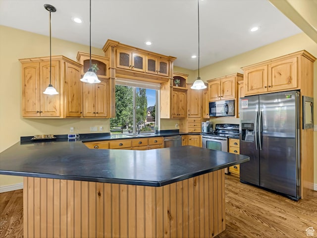 385 W Riverside Ln, Spanish Fork, UT 84660 - kitchen featuring appliances with stainless steel finishes, dark countertops, wood finished floors, light brown cabinets, and a peninsula