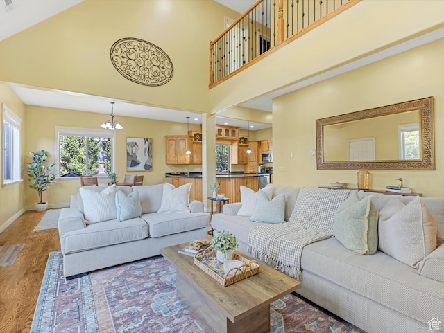 385 W Riverside Ln, Spanish Fork, UT 84660 - living room with a chandelier, light wood-style floors, and a towering ceiling