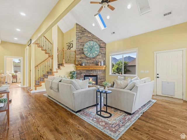 385 W Riverside Ln, Spanish Fork, UT 84660 - living area featuring a ceiling fan, wood finished floors, high vaulted ceiling, stairs, and a stone fireplace