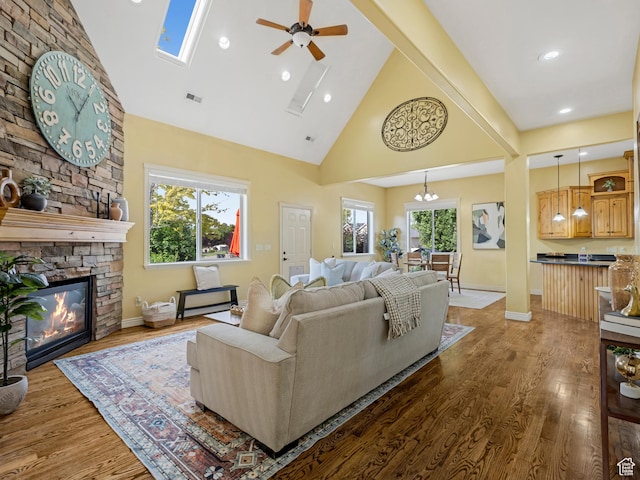 385 W Riverside Ln, Spanish Fork, UT 84660 - living room featuring high vaulted ceiling, a ceiling fan, wood finished floors, a stone fireplace, and recessed lighting