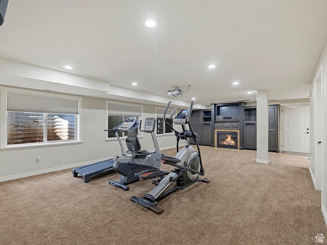 385 W Riverside Ln, Spanish Fork, UT 84660 - exercise area featuring carpet floors, a glass covered fireplace, and recessed lighting