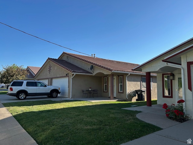 2839 S Vanburen Ave E Unit 8, Ogden, UT 84403 - view of front of property with a garage, a front yard, stucco siding, and a tile roof