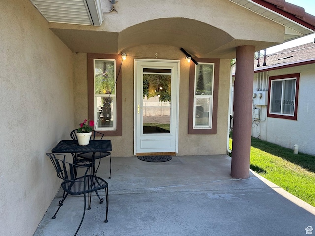 2839 S Vanburen Ave E Unit 8, Ogden, UT 84403 - view of exterior entry featuring stucco siding and a patio area
