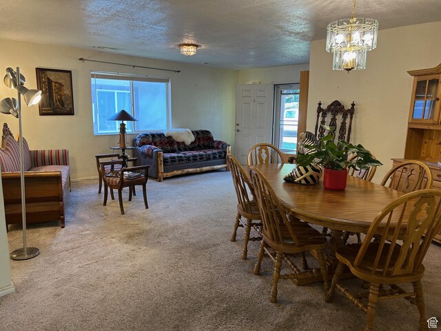 2839 S Vanburen Ave E Unit 8, Ogden, UT 84403 - carpeted dining area with plenty of natural light, a chandelier, and a textured ceiling
