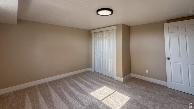 7166 S 4000 E, Price, UT 84501 - unfurnished bedroom with light colored carpet, a closet, and a textured ceiling