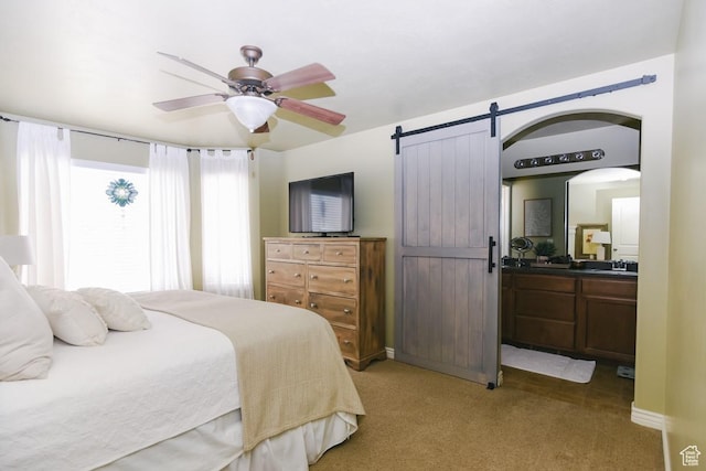 615 W 850 N, Tooele, UT 84074 - bedroom featuring light carpet, a barn door, ensuite bathroom, and a ceiling fan