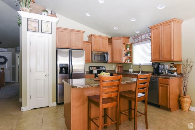 615 W 850 N, Tooele, UT 84074 - kitchen with appliances with stainless steel finishes, vaulted ceiling, a kitchen island, light tile patterned floors, and dark stone counters