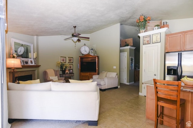 615 W 850 N, Tooele, UT 84074 - living area featuring a ceiling fan, a fireplace, light tile patterned floors, and light colored carpet