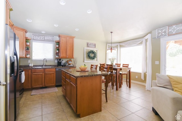 615 W 850 N, Tooele, UT 84074 - kitchen with open shelves, appliances with stainless steel finishes, a kitchen breakfast bar, light tile patterned flooring, and a kitchen island