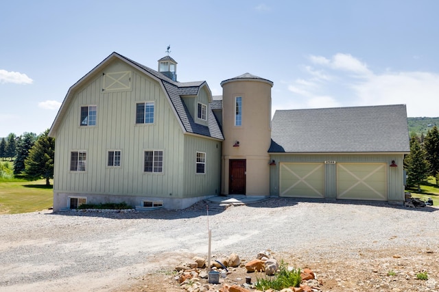 2599 S Foxridge Rd, Garden City, UT 84028 - view of front of house with a garage, driveway, a shingled roof, and a gambrel roof