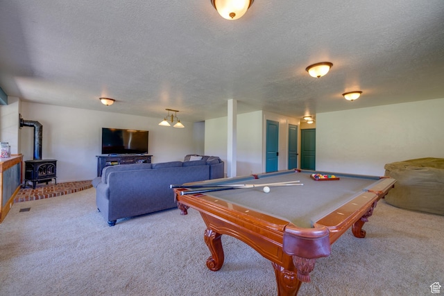 2599 S Foxridge Rd, Garden City, UT 84028 - playroom featuring light colored carpet, a wood stove, a textured ceiling, and billiards table