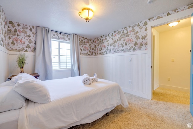 2599 S Foxridge Rd, Garden City, UT 84028 - bedroom featuring wallpapered walls, wainscoting, and carpet flooring