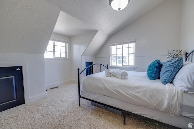 2599 S Foxridge Rd, Garden City, UT 84028 - carpeted bedroom featuring vaulted ceiling and a textured ceiling