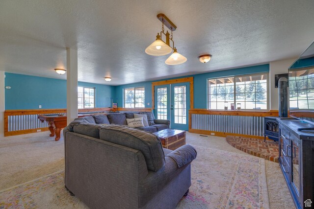 2599 S Foxridge Rd, Garden City, UT 84028 - carpeted living room featuring a wood stove, a textured ceiling, french doors, and billiards table