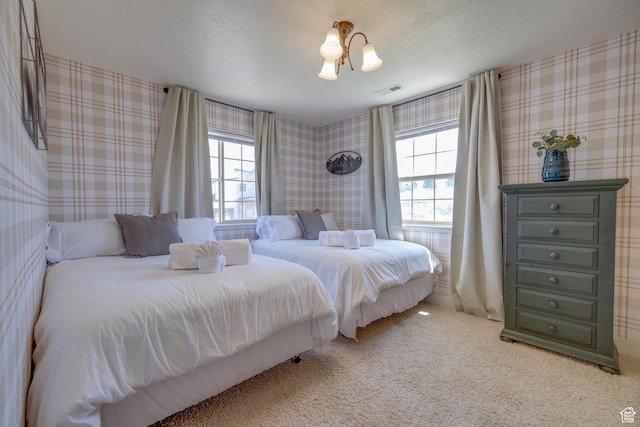 2599 S Foxridge Rd, Garden City, UT 84028 - bedroom featuring multiple windows, carpet, and wallpapered walls