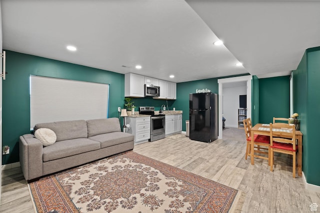 4892 E Lake Corner Dr, Eagle Mountain, UT 84005 - living room with light wood-type flooring and recessed lighting