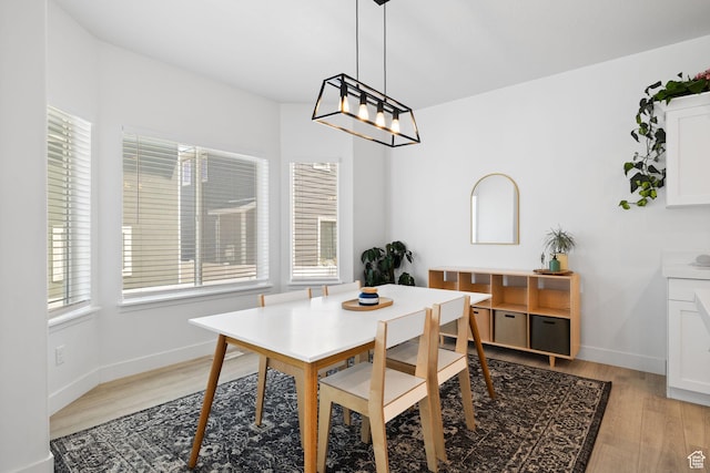 4892 E Lake Corner Dr, Eagle Mountain, UT 84005 - dining space with plenty of natural light, light wood-style flooring, and a chandelier
