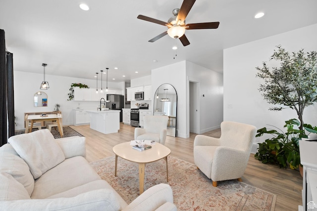 4892 E Lake Corner Dr, Eagle Mountain, UT 84005 - living room featuring a ceiling fan, recessed lighting, and light wood-style flooring