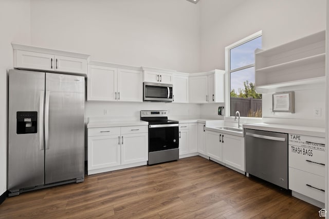 4892 E Lake Corner Dr, Eagle Mountain, UT 84005 - kitchen with stainless steel appliances, white cabinets, a towering ceiling, open shelves, and light countertops