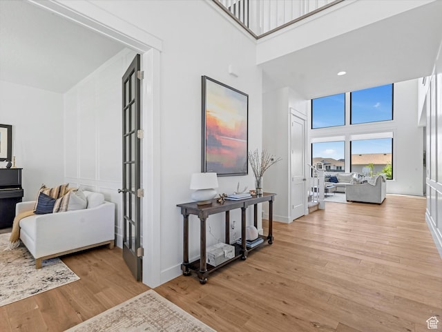 1172 E Candy Ln, American Fork, UT 84003 - corridor with a towering ceiling, light wood-style floors, and french doors