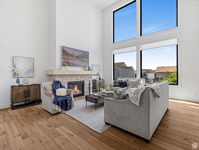 1172 E Candy Ln, American Fork, UT 84003 - living area with a high ceiling, a stone fireplace, and wood finished floors