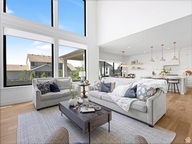 1172 E Candy Ln, American Fork, UT 84003 - living room featuring plenty of natural light, light wood-style floors, recessed lighting, and a high ceiling