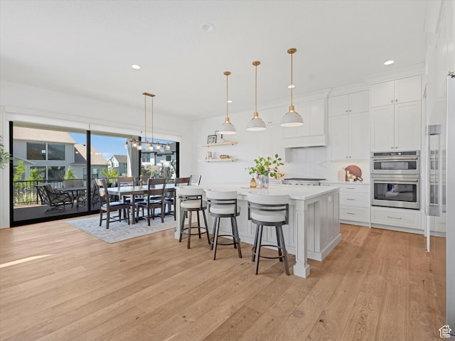 1172 E Candy Ln, American Fork, UT 84003 - kitchen featuring double oven, light countertops, light wood-type flooring, white cabinets, and open shelves