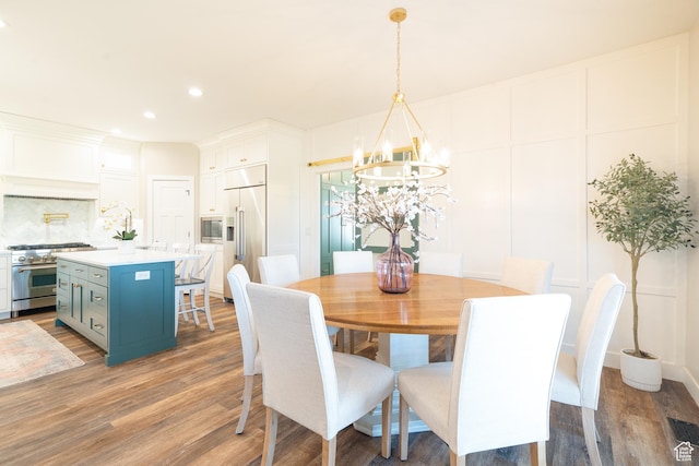 986 View Crest Ln, Kaysville, UT 84037 - dining area featuring a chandelier, a decorative wall, wood finished floors, and recessed lighting
