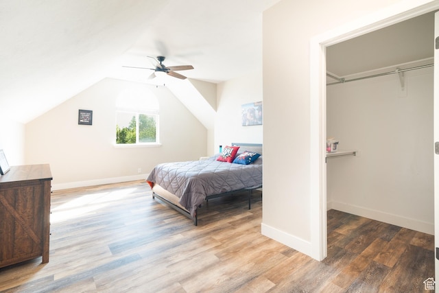 986 View Crest Ln, Kaysville, UT 84037 - bedroom with wood finished floors, vaulted ceiling, a ceiling fan, and a walk in closet
